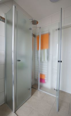 Helle Dusche mit Glasabtrennung im Badezimmer des Ferienhauses Urban